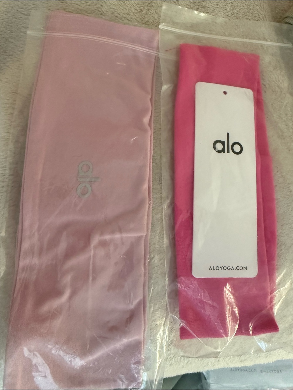 ALO Yoga Light Pink & Hot Pink Stretch Headbands. And one pair of socks.